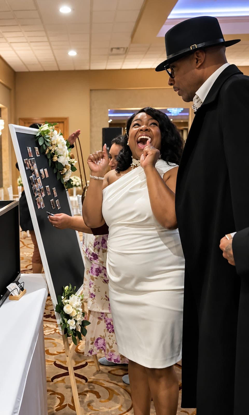 Bride laughing with delight as she looks at her wedding photo magnets on the Memory Board at a Metro Detroit reception